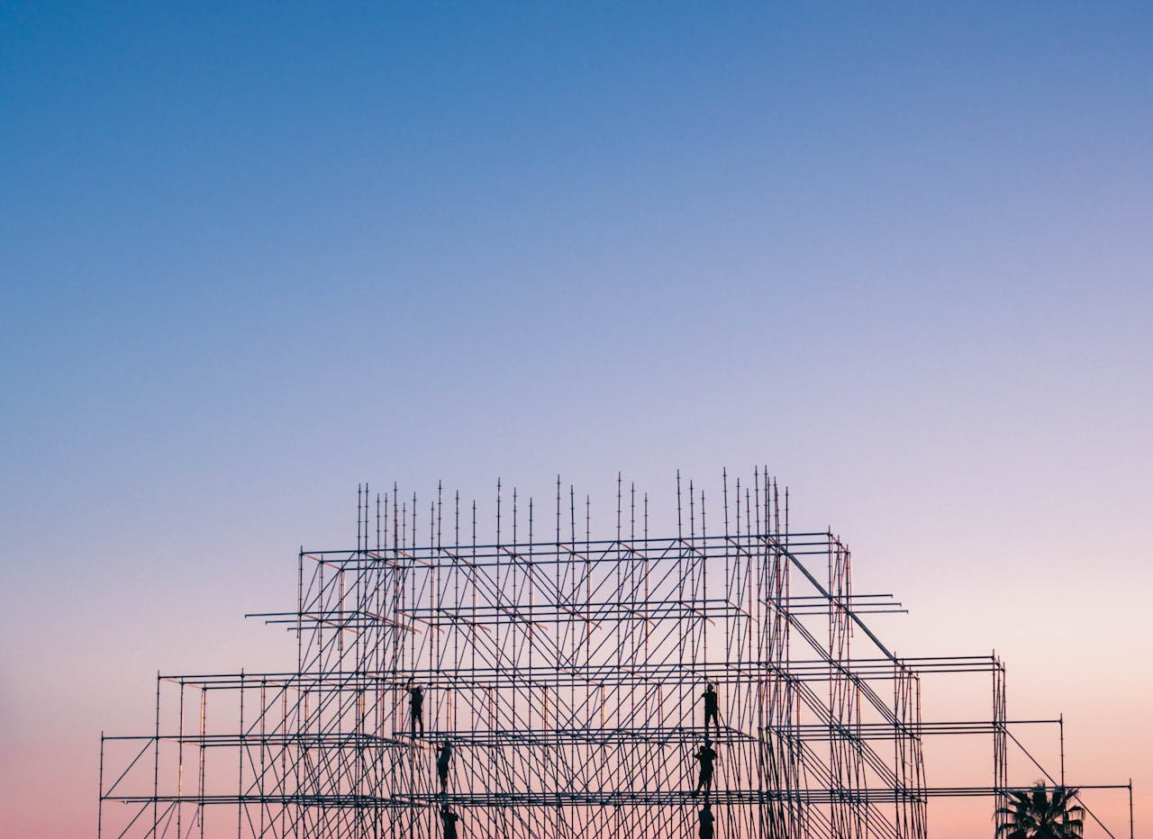 about-us A silhouetted structure against a colorful sunset, showcasing industrial scaffolding in Sochi, Russia.